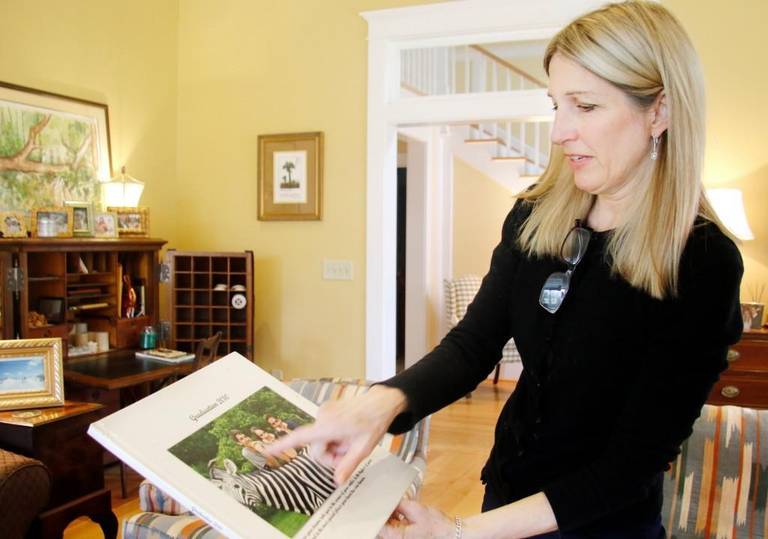 Ramona Sheridan looks at a picture of her daughter, Olivia Williams, who attended Central High School while her siblings attended Mount de Sales. 