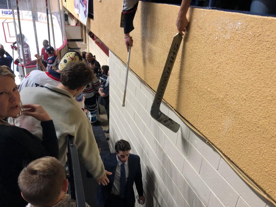Fans hang their hands over the railing and high-five players and coaches in this Mayhem file photo.