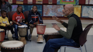 Brother Kwama teaching kids how to play the African drums at the Tubman Museum in February 2019.
