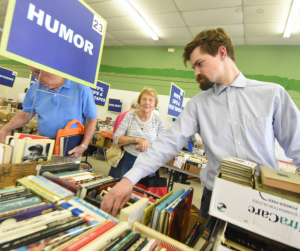 Customers browse the humor section at the Friends of the Library Macon book sale in 2018. Photo credit: Friends of the Library Macon