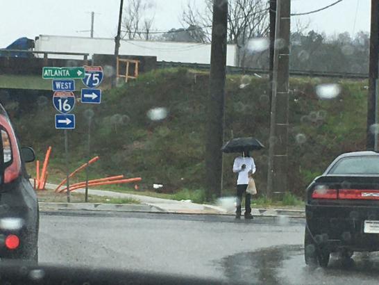There are also Macon residents who chose to ignore the signs. A pedestrian is shown after continuing through the roadwork in the rain. Photo credit: Angel Colquitt