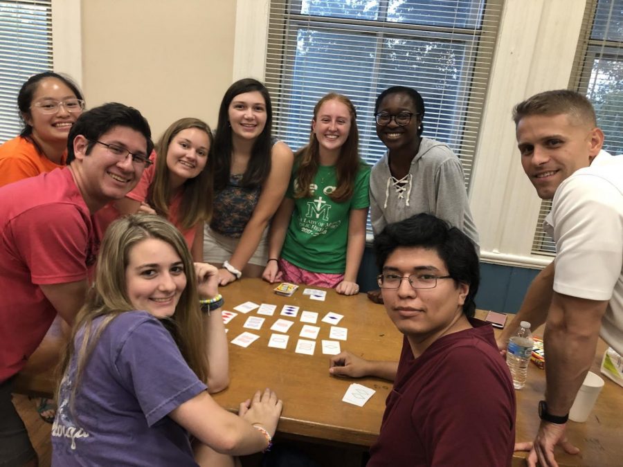 A group of members of Mercer’s Catholic Campus Ministry enjoy each other’s company as they play a card game at their first meeting of the year in August 2019.