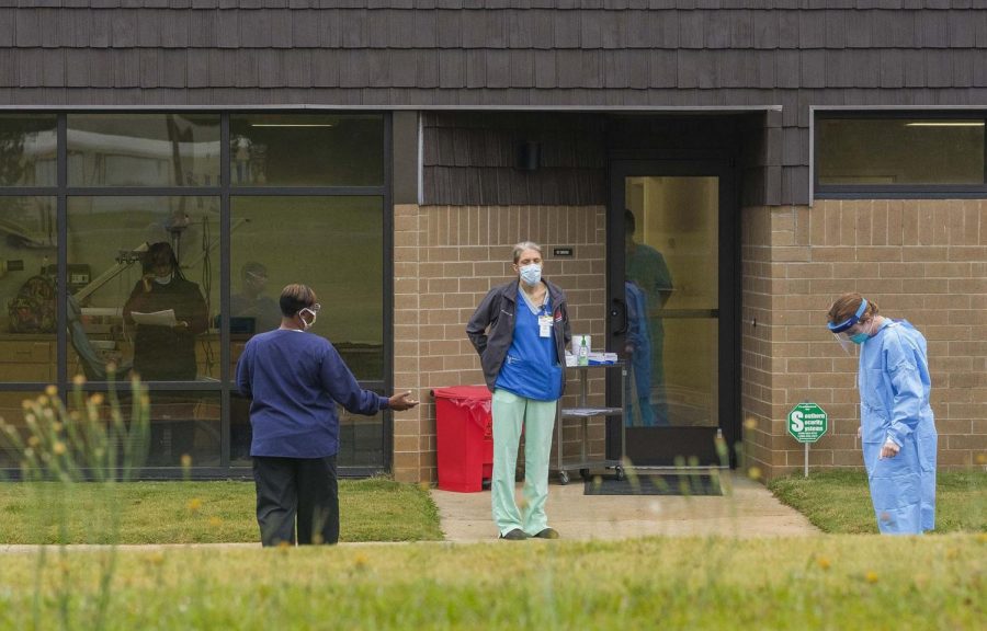 Technicians at the Hancock County Health Department wait to perform a coronavirus test in May. The virus spread in Hancock has been labeled severe. 