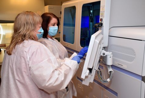 Medical Center, Navicent Health, medical lab technicians Diane Jones, left, and Jeri Fountain, use the new Roche Cobas 6800 testing machine that will allow the hospital to do all its COVID-19 testing in house.