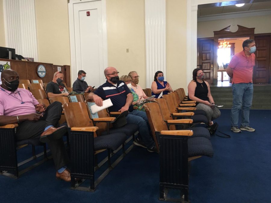 Neighbors opposed to the Travel Centers of America truck stop on Sardis Church Road voice  frustrations during a delay in Mondays hearing at Macon-Bibb County Commission chambers. 