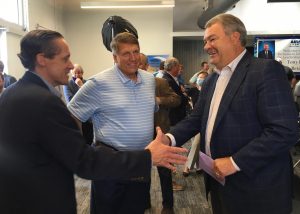 Macon Housing Authority CEO Mike Austin, left, shakes hands with former Macon Water Authority executive director Tony Rojas during his retirement celebration last month. 