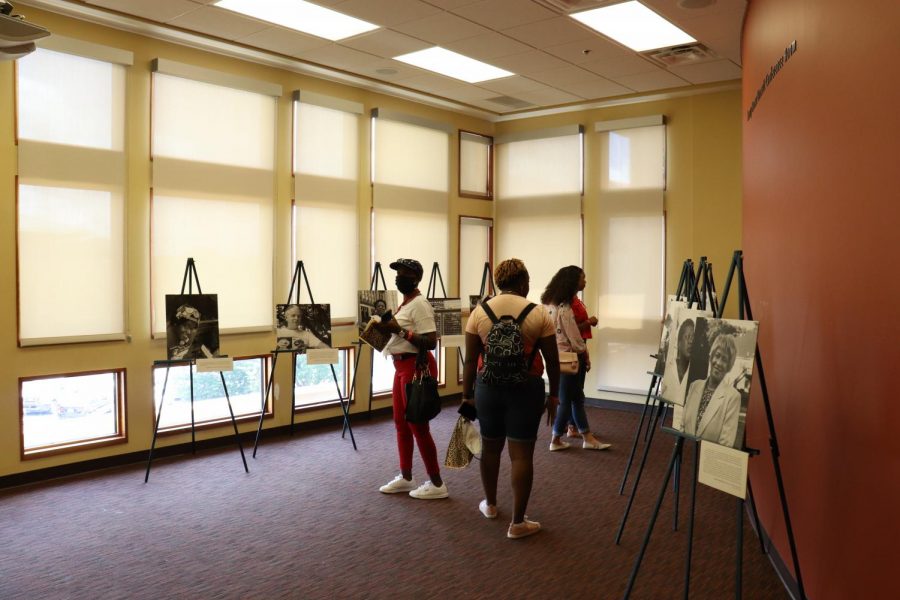 Guests view the photography exhibit featured by Georgia Equality at the Tubman Museum. 