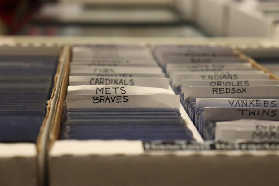 The Atlanta Braves headline a list of cards from different teams, all placed in protective plastic cases called toploaders to be sold.