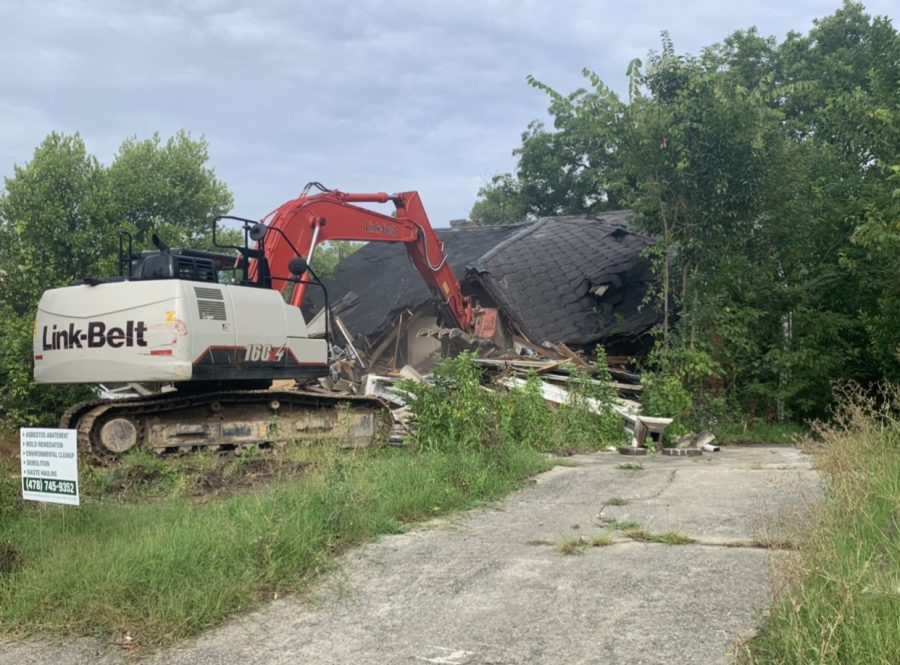 One of the houses being demolished next to the community center after the press conference