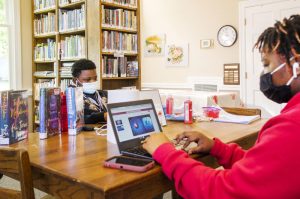 Siblings Quinyonna Tooks, right, and Charles Knott do their schoolwork in the Oglethorpe Library in Macon County. Charles is not a fan of remote learning. “I dont like it,” he said. “In school is better for me. I can focus in there with the teachers.”