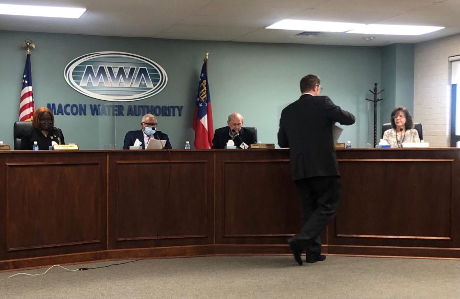 Macon Water Authority special counsel David Cooke passes out copies of his report on the conduct of MWA Board Member Desmond Brown during a called meeting in January. 