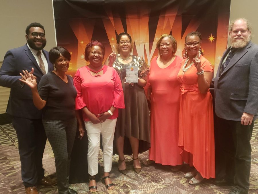 Macon-Bibb County Elections Supervisor Jeanetta Watson, center, poses with the Phoenix Award during the Georgia  Association of Voter Registration and Election Officials conference last summer.