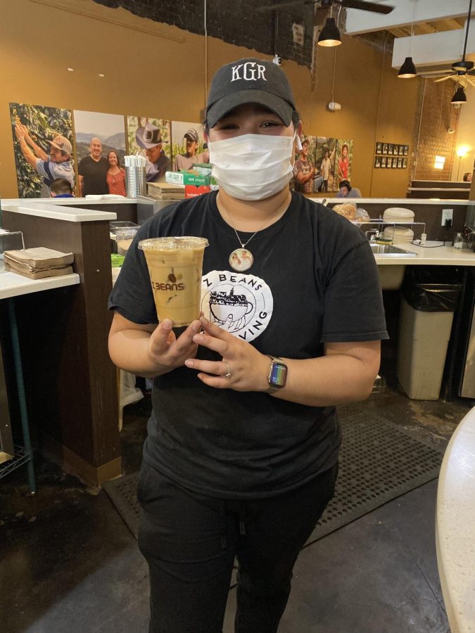 A Z-Beans barista poses with the coffee she just made. 
