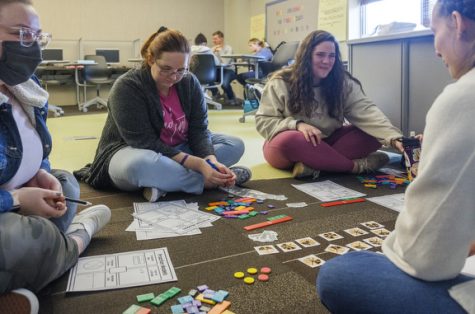 Middle Georgia State University third year teaching students, from left, Myah Anderson, Raven Moffitt, Emily Dent and Hannah Nichols work through techniques to teach fourth grade students the basics of fractions. Their final year in the MGA program will see them teaching full time in an area school.