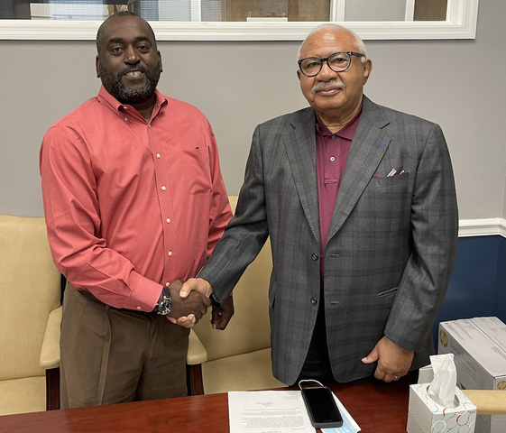 Macon Water Authority Chairman Sam Hart, right, congratulates interim board member Sheddrick Clark who will represent District 2 on the authority until a special election can be held in November. 