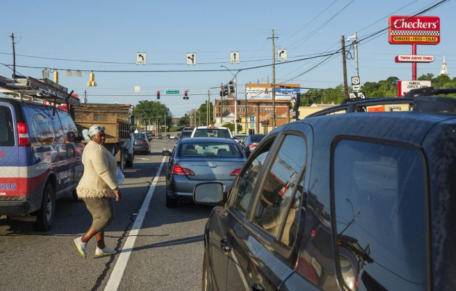 Mika Shills crosses Spring Street in Macon with the red light going her way by about 20 yards from the crosswalk a few hours after another pedestrian was hit and killed near the same spot. Shills is careful about crossing Macon roadways on foot but says nowhere is really safe to do it. 