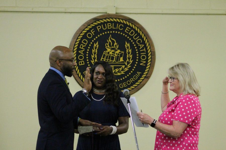Bibb Schools Superintendent Dan Sims is sworn in to office by Bibb County Probate Judge Sarah Harris. His wife, Traci, holds a Bible. 