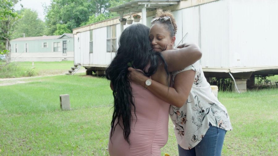 Rural OB-GYN hugs patient. 