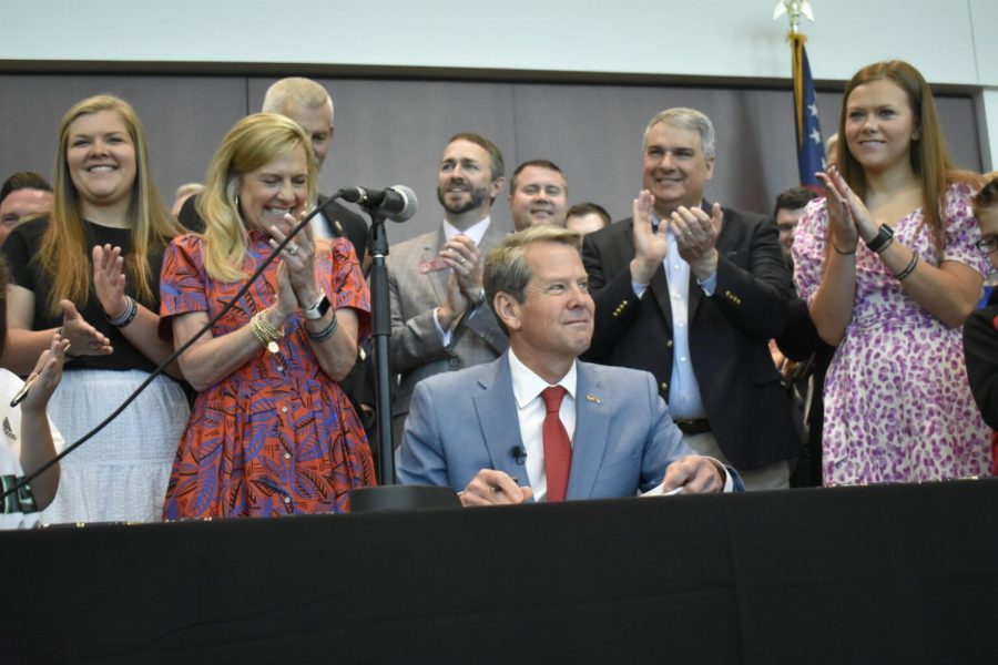 Gov.+Brian+Kemp%E2%80%99s+2023+priorities+for+Georgia%E2%80%99s+K-12+students+include+more+funding+for+school+counselors+and+grants+for+parapros+to+become+teachers.+Pictured%2C+Kemp+signs+education+bills+in+April.+2022.