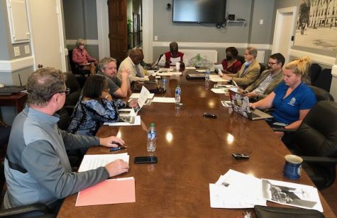 Members of the Macon-Bibb County Bicentennial Committee look over sample logos during their September meeting at City Hall. The diverse group of local leaders is planning events to commemorate the citys 200th anniversary in 2023.