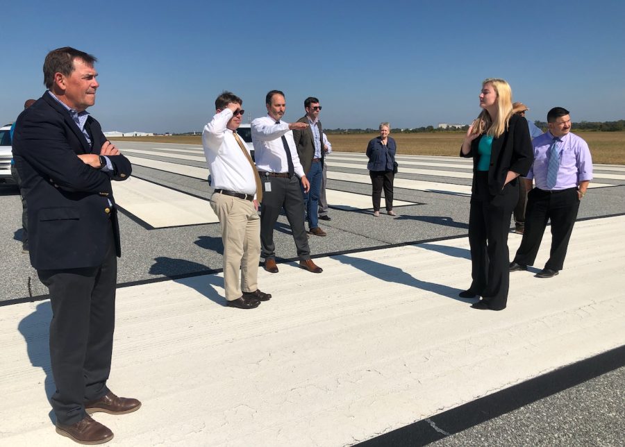 Doug Faour, center left, gestures toward the planned runway extension during a recent tour of the Middle Georgia Regional Airport with the Macon-Bibb County Planning & Zoning Commission.