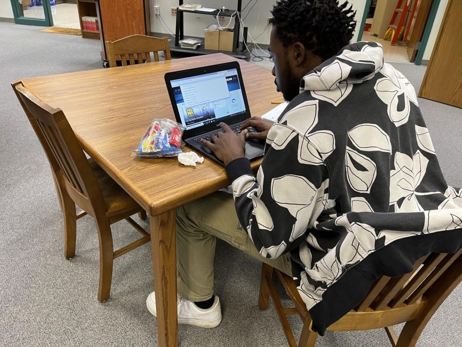 A SOAR Academy student works on their homework in the media center at SOAR Academy. “In the media center. they just doing their own thing,” Director of Personalized Learning and Alternative Education Julia Daniely said. “They might be chatting with their friends, but then theyll do their work. But see, that disturbs the traditional setting, this would disturb but we are a disturbance to the traditional setting.”