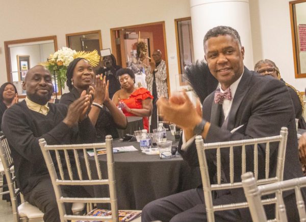 Rep. James Beverly, D-Macon, right, applauds a speaker at the black-tie fundraising gala for the Macon-Bibb Community Enhancement Authority in the rotunda of the Tubman African American Museum on Oct. 29, 2022.