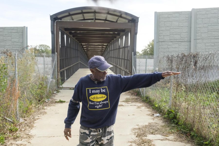Peter Givens stands near the entrance of a pedestrian bridge over Interstate 75 that connects the west an east sides of the Pleasant Hill neighborhood. The neighborhood was severed in the 60s with the construction of Interstate 75.