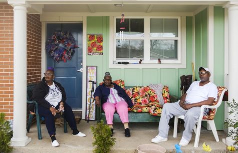 Diane Collins, left, her mother Bernice Smith, center and their friend Tony Fordham, on the porch of Collins Davis Place apartment.