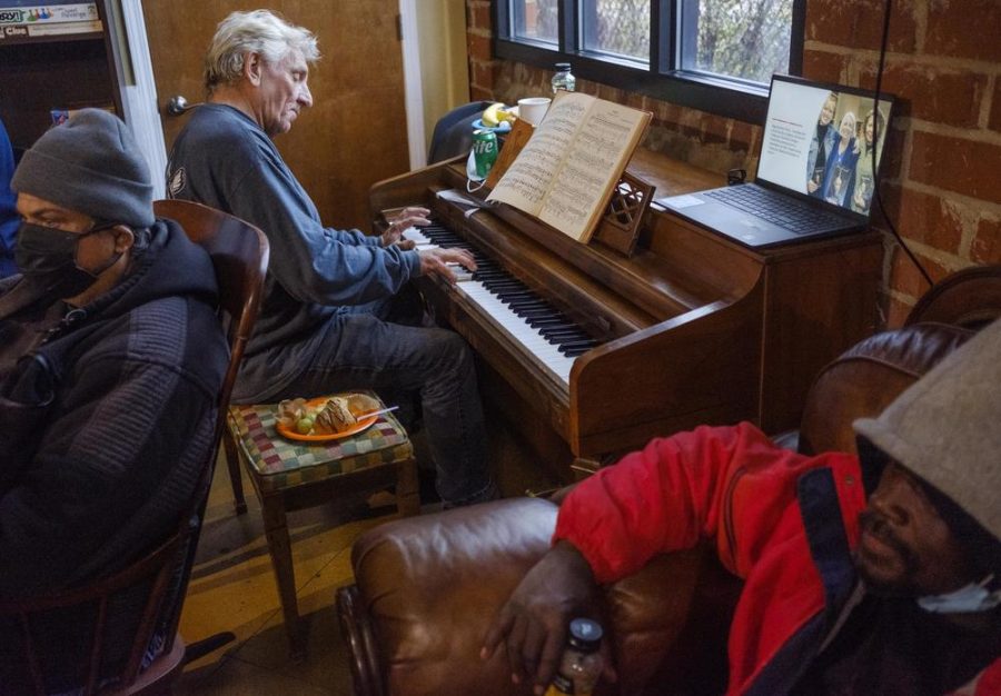 Randy Bedingfield plays the piano during a November reception at the Daybreak Day Center, which offers an array of services to the unhoused in Macon. Daybreak is privately funded but a Georgia Senate bill would audit public funds spent on such services.