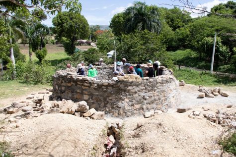 Mercer engineering students, along with Sabana Bonita community members construct the water tank walls with stone and mortar. Community members had to sign up for shifts to help construct the tank in addition to paying the fees to maintain the tank. 