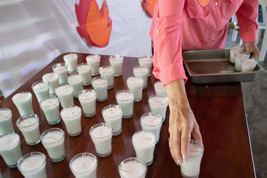 Joana Peterson arranges candles that will be handed out to leaders of each community during the mass that follows the Pentecost celebration. 