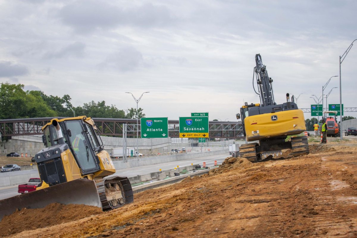 Two bulldozers operating in front of a major interstate expansion project