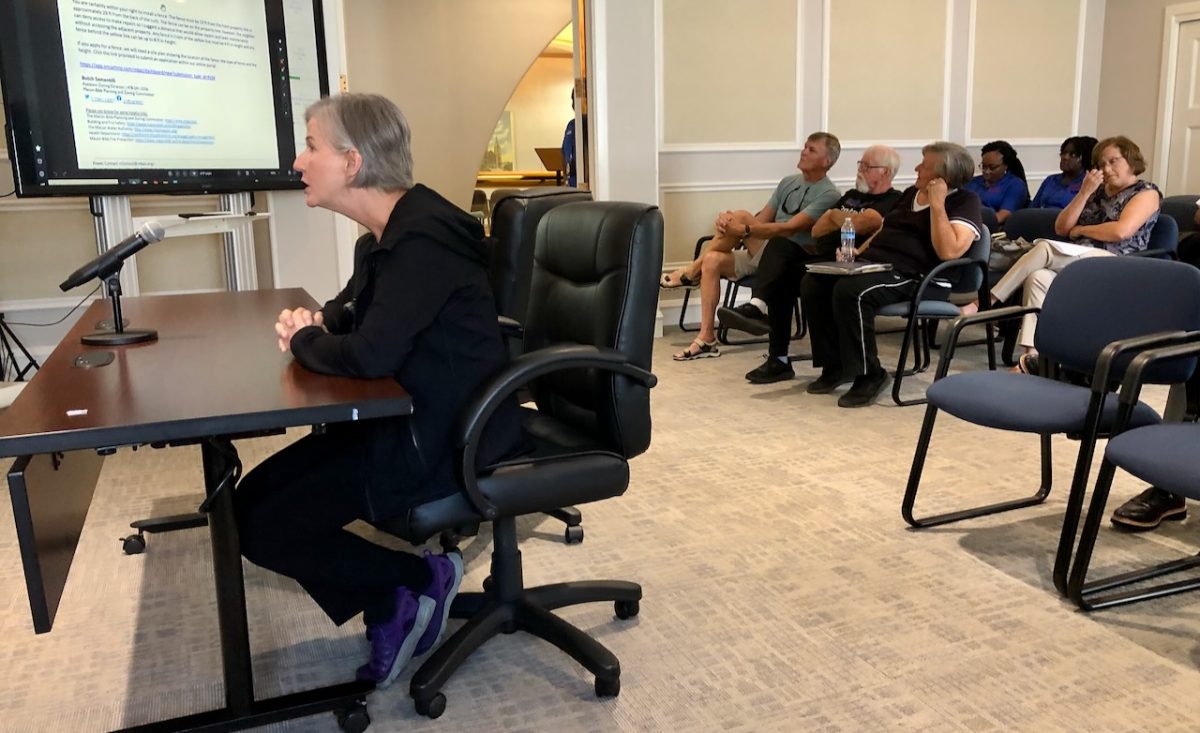 Mitzi Matthews makes her case for fence variances as her Kay Drive neighbors look on from the front row during the Aug. 14 P&Z meeting. Matthews did not apply for a permit and did not follow P&Zs regulations in erecting the fence in response to neighbors alleged actions.