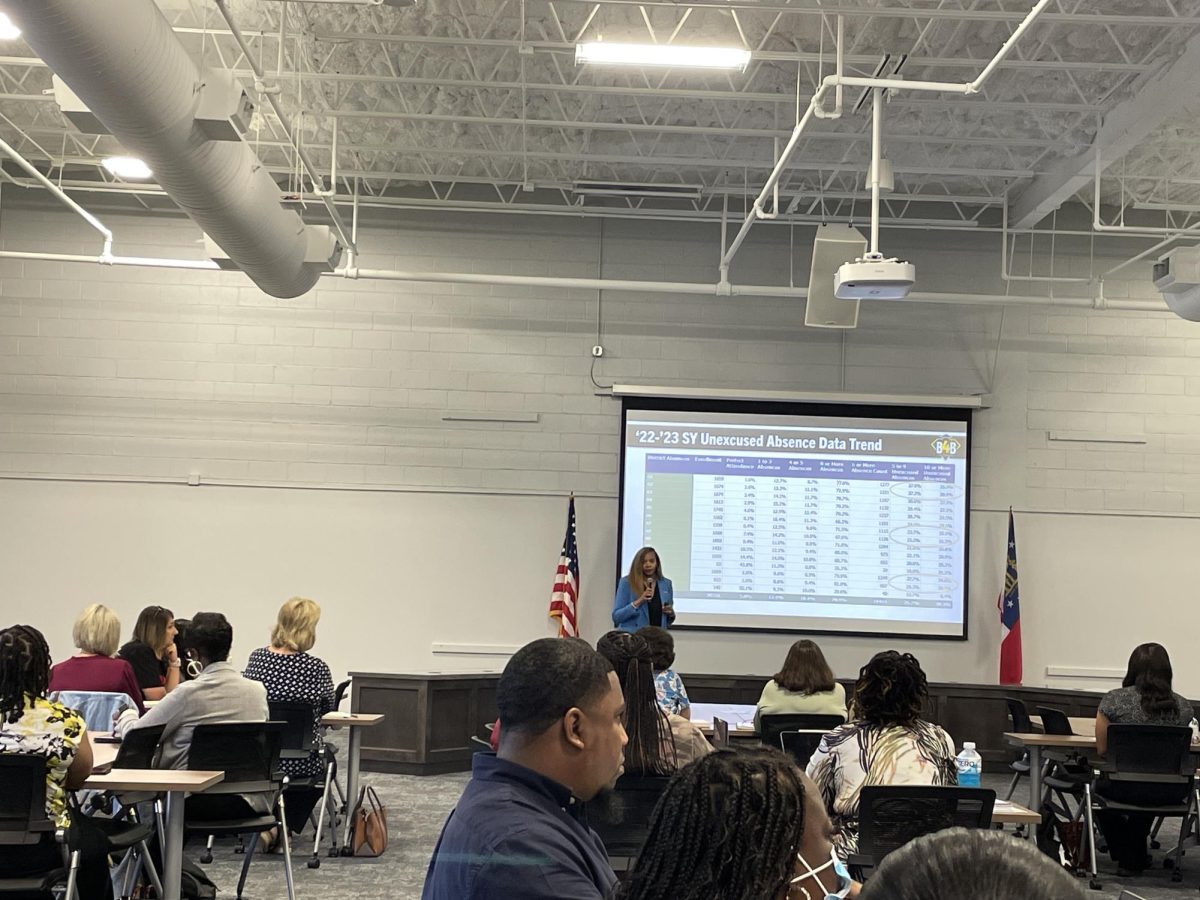 Takeysha Lewis, attendance and transfer coordinator for Bibb County public schools, presents student attendance data to social workers, counselors and principals of elementary and middle schools during a meeting early Sept. 11, 2023, at the Professional Learning Center on Riverside Drive.