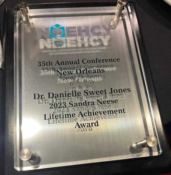 A plaque for the 2023 recipient of the Sandra Neese Lifetime Achievement Award was bestowed to Danielle Jones, homeless and foster care liaison for Bibb County School District, at the National Association for the Education of Homeless Children and Youth annual conference in November 2023.