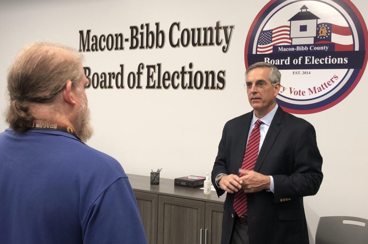 Georgia Secretary of State Brad Raffensperger, right, visits with Macon-Bibb County Elections Supervisor Tom Gillon during an October tour of the new Board of Elections office at Macon Mall. 