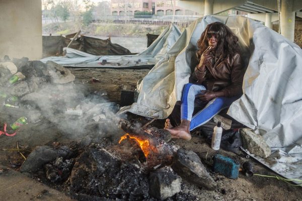 A small fire re-ignited with hand sanitizer as an accelerate warms Conta Prices feet on a 28 degree morning in Macon in late November. Price said depending on who you talk to on the street, you will hear maybe Macons Salvation Army shelter is open to single adults, or maybe it isnt.