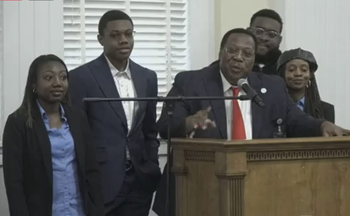 Macon-Bibb County Commissioner Al Tillman, flanked by his family, resigned his District 9 seat at the conclusion of the Jan. 9 Committee of the Whole  meeting. 