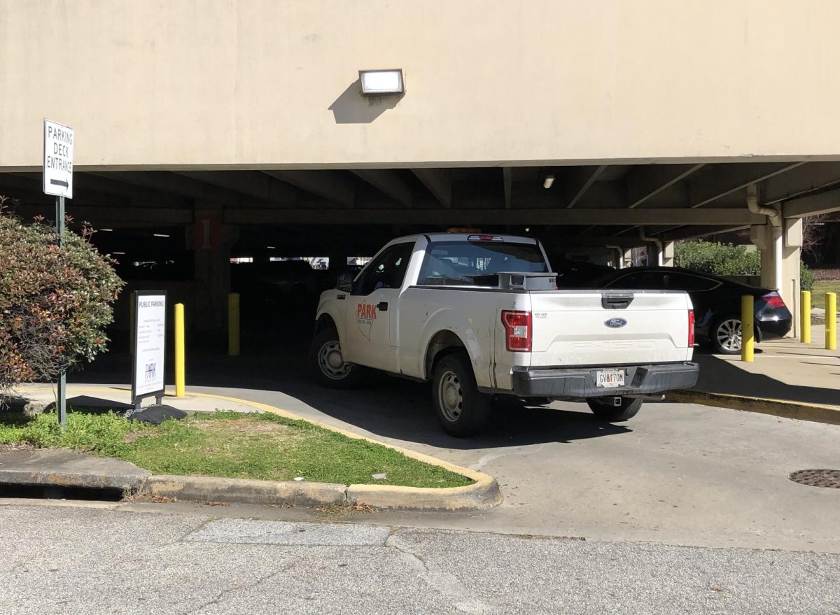 A Park Macon employee takes a spin through the 440 Mulberry St. parking deck, which is now operated through a contactless online payment system.