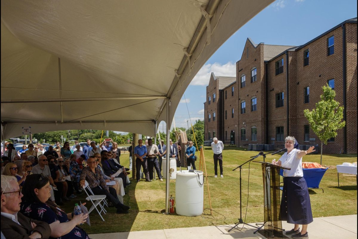 Sister Theresa Sullivan, right, speaks during a ceremony May 20, 2024, marking the near-completion of Macons Central City Apartments.