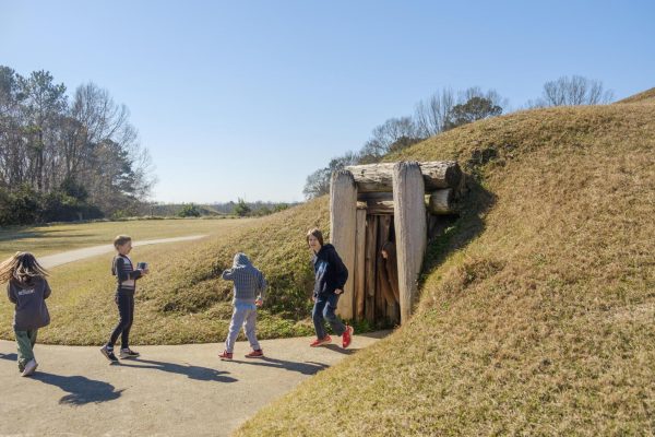 Students leave the Earth lodge, thought to be used historically as a council space, at the Ocmulgee Mounds National Historic Park in Macon in 2022.