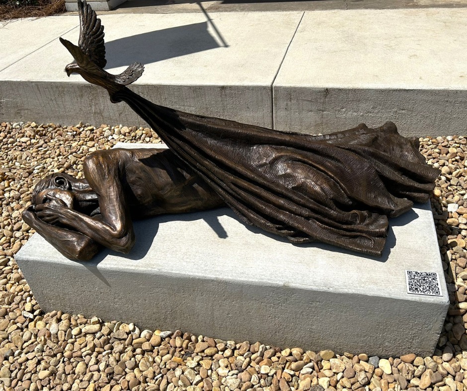 Sheltering, a sculptural piece by Timothy Schmalz, is installed in honor of the new Central City Apartment Complex that will help Maconites struggling with housing insecurity.