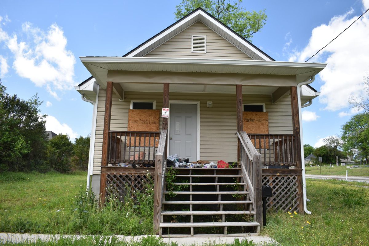 The Macon-Bibb County Community Enhancement Authority build this house at 231 Moughon Street Lane in 2020. Four years later, it is vacant with trash on the porch, boarded up windows and tall grass. 