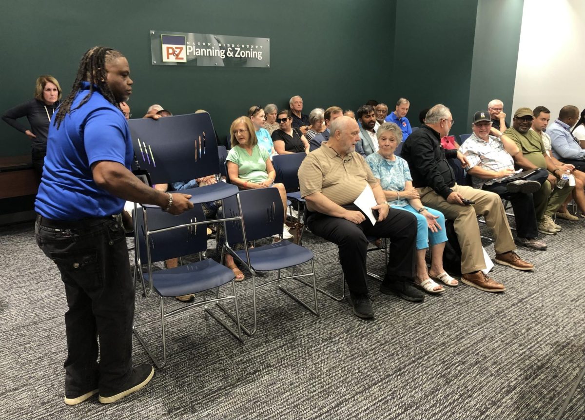 Lead zoning inspector Eric White puts out more chairs for Mondays Macon-Bibb County Planning & Zoning Commission hearing that drew residents of the Oakview neighborhood opposed to new phases of denser housing. 