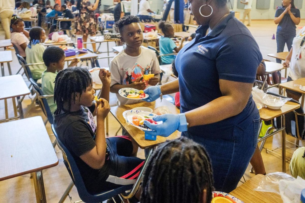 Kids at the Boys and Girls Club on Anthony Road in Macon get their second helpings of fresh fruit and vegetables through the Happy Helpings summer food program recently.