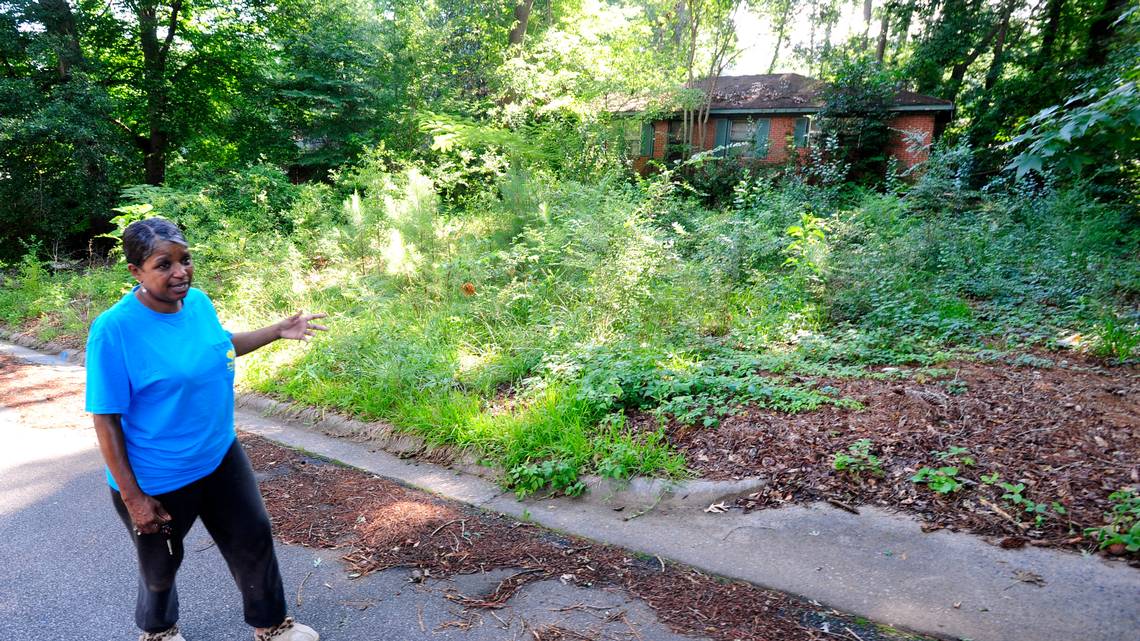 Genester Marshall has gone to Municipal Court to try and hold the owner responsible for this blighted Knightsbridge Road home. Marshall outside the home in August 2014.
