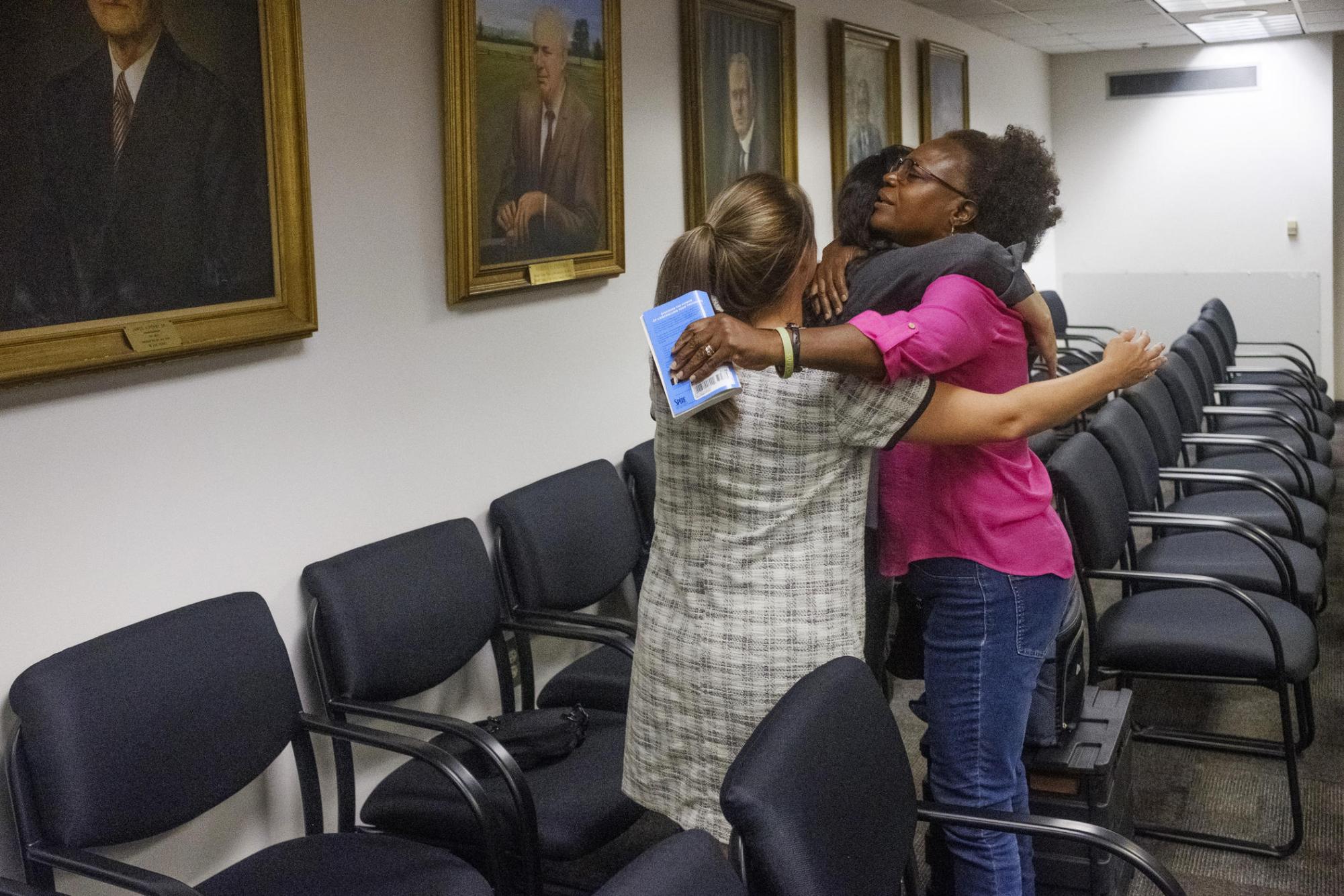 Jan Smith hugs members of her legal team after the final hearing before Georgia's Public Service Commission on the issue of whether or not a local railroad can use eminent domain to take rural land which has been in her husband's family since the 1920s.