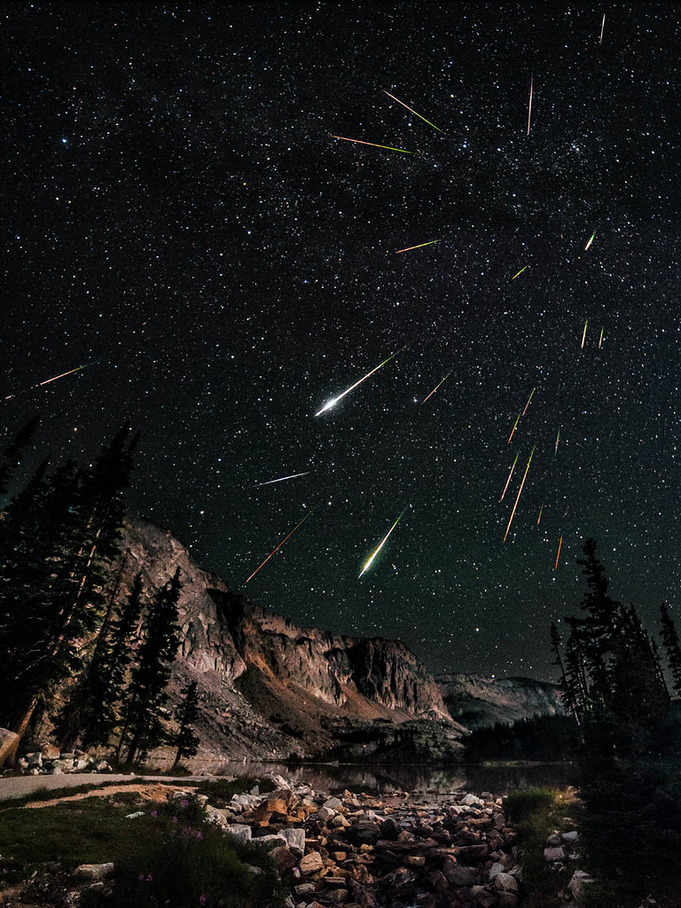 A composite image of the 2012 Perseids meteor shower shot at Snowy Range in Wyoming by photographer and instructor David Kingham. 

This is a composite image of 23 photos, 22 for the meteors/stars and 1 taken at sunrise for the foreground which was lightly blended in.  

Read the full explanation here https://flic.kr/p/cQwNCL