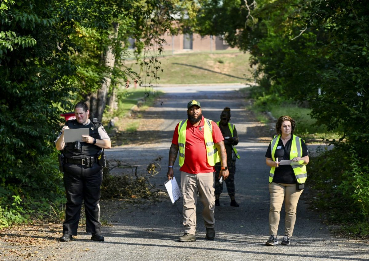 Members of Keep Macon-Bibb Beautiful, the United Way of Central Georgia and community volunteers walk along Watkins Lane while participating in a Walking School Bus audit for Burdell-Hunt Elementary School Tuesday.